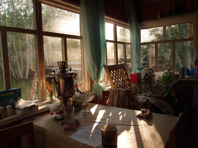Table with pitcher and glasses in front window