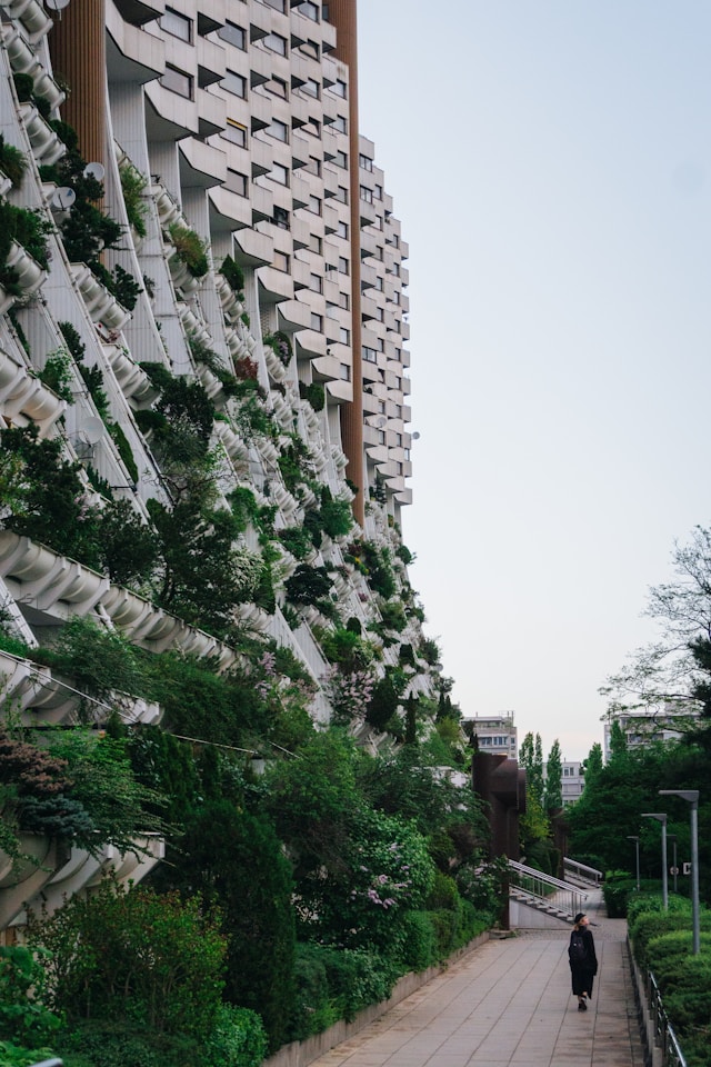 Building with green plants growing from lower half
